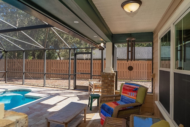 exterior space with a fenced in pool, glass enclosure, a fenced backyard, and a patio