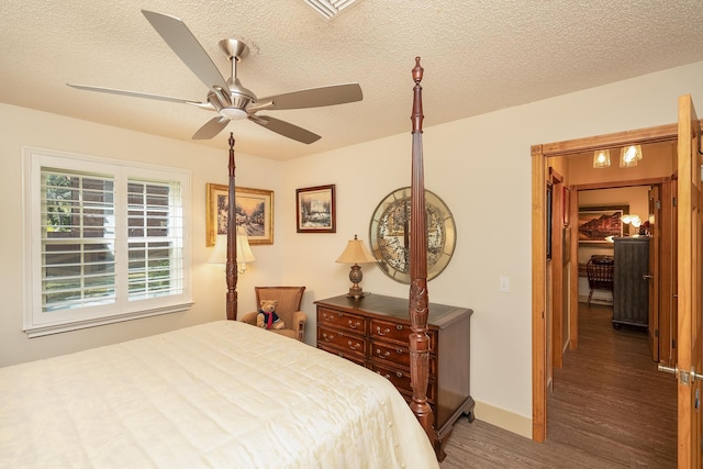 bedroom featuring a textured ceiling, a ceiling fan, and wood finished floors