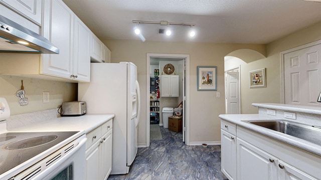 23213 Harbour Vista Cir, Saint Augustine, FL 32080 - kitchen with white appliances, extractor fan, white cabinets, arched walkways, and light countertops