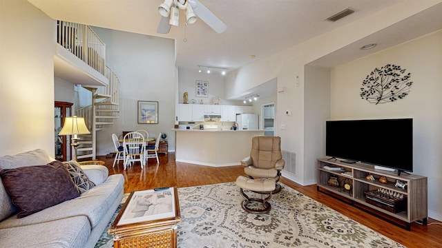 23213 Harbour Vista Cir, Saint Augustine, FL 32080 - living room featuring a ceiling fan, a high ceiling, and wood finished floors