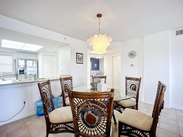 dining room featuring visible vents, light tile patterned floors, and a notable chandelier