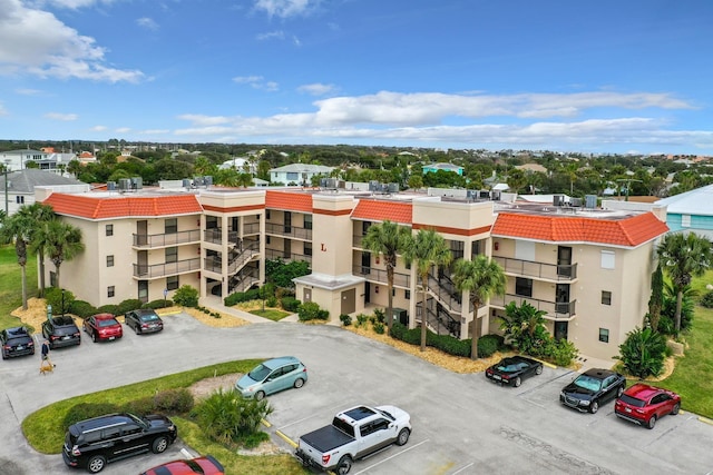 view of building exterior with uncovered parking