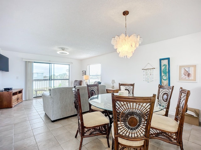 dining space featuring an inviting chandelier and light tile patterned flooring