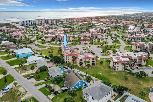 birds eye view of property featuring a water view and a city view
