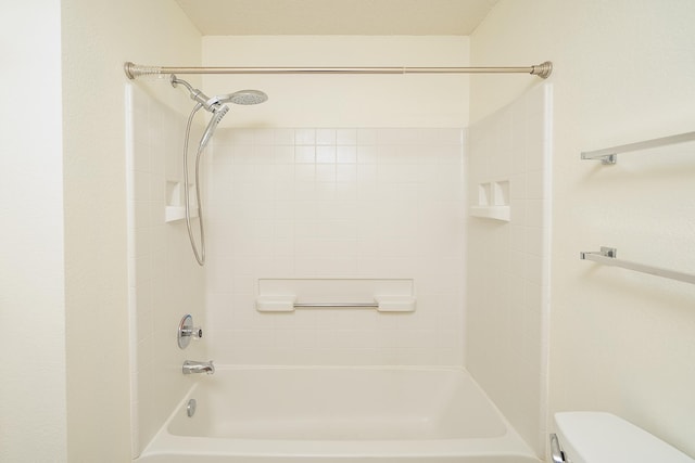 bathroom featuring bathing tub / shower combination and toilet