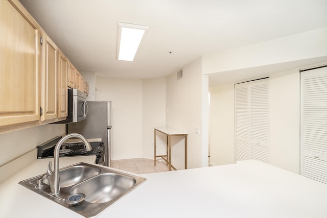 kitchen featuring light tile patterned flooring, sink, and light brown cabinets