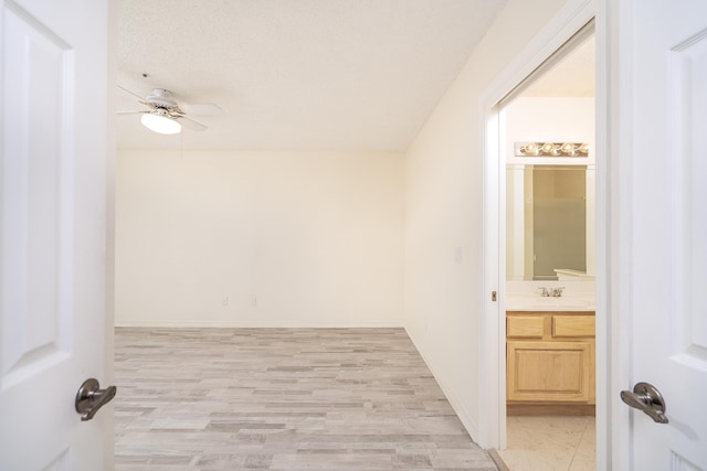 bathroom featuring vanity, a textured ceiling, and ceiling fan