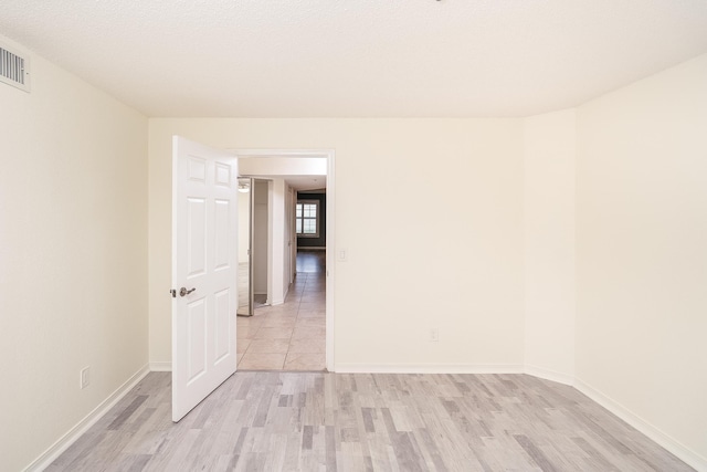 empty room with light hardwood / wood-style flooring