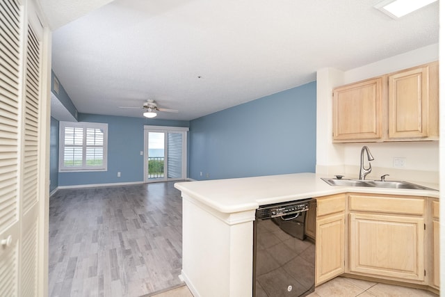 kitchen with light brown cabinetry, black dishwasher, sink, ceiling fan, and kitchen peninsula