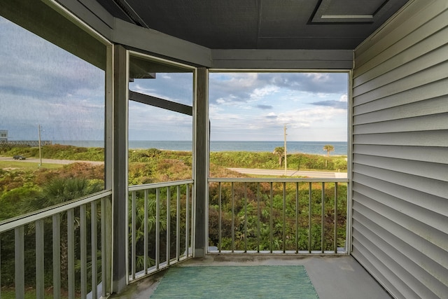 unfurnished sunroom featuring plenty of natural light and a water view