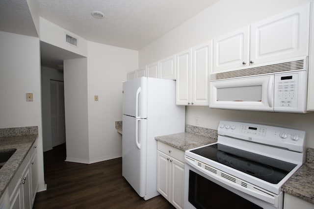 kitchen featuring light stone counters, a textured ceiling, white appliances, dark hardwood / wood-style floors, and white cabinetry