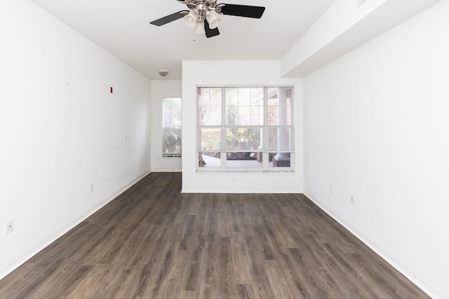 empty room featuring dark hardwood / wood-style floors and ceiling fan