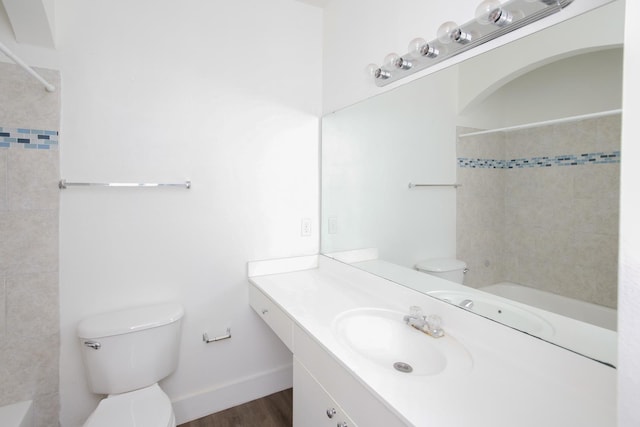 full bathroom with hardwood / wood-style flooring, tiled shower / bath combo, toilet, and vanity