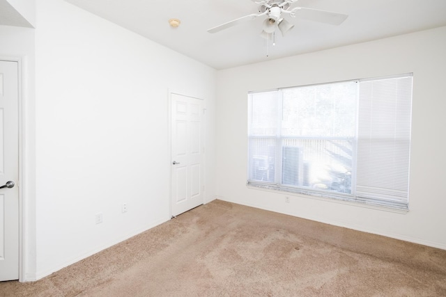 carpeted empty room with ceiling fan