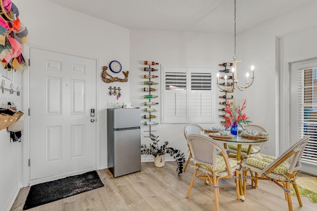 dining area featuring a chandelier and light wood-type flooring