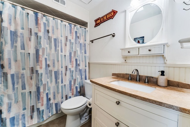 4502 Sandcastle Cir, Saint Augustine, FL 32084 - bathroom with a wainscoted wall, vanity, a shower with shower curtain, and tile patterned floors