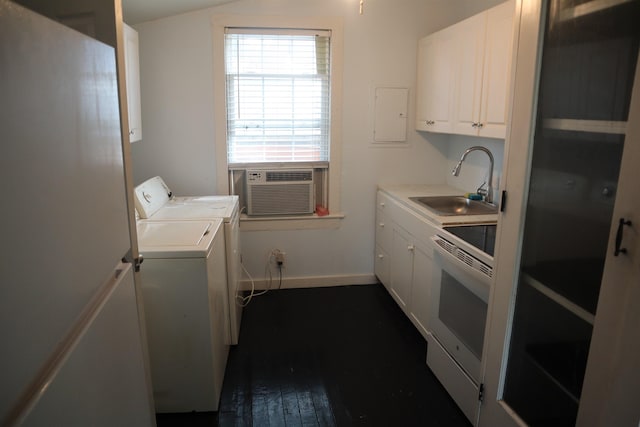 washroom featuring sink, dark hardwood / wood-style floors, electric panel, cooling unit, and washer and clothes dryer