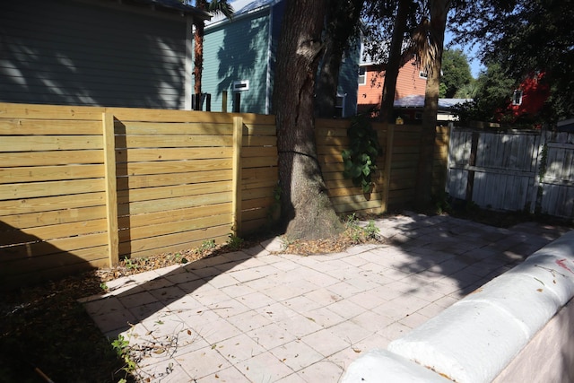 view of gate featuring a patio