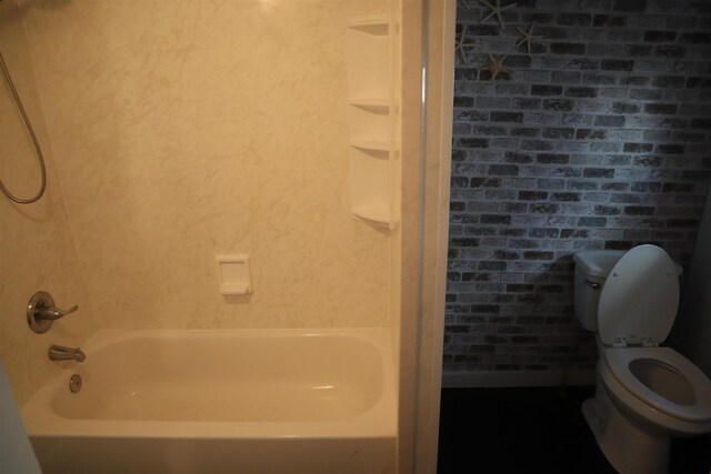 bathroom featuring toilet and bathtub / shower combination