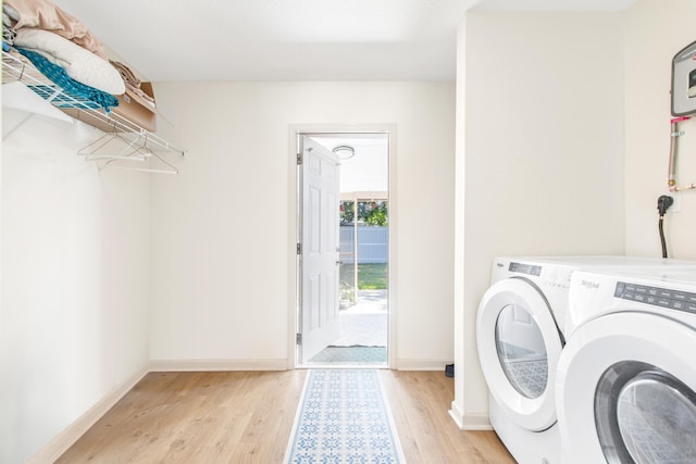 laundry area featuring light wood-type flooring and separate washer and dryer