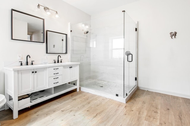 bathroom with vanity, wood-type flooring, and walk in shower