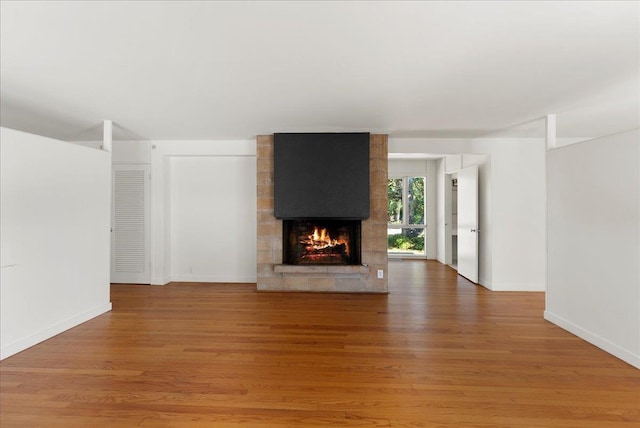 201 Arpieka Ave, Saint Augustine, FL 32080 - unfurnished living room with a fireplace, light wood-style flooring, and baseboards