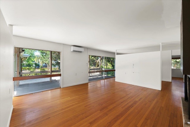 201 Arpieka Ave, Saint Augustine, FL 32080 - spare room with an AC wall unit, healthy amount of natural light, wood finished floors, and baseboards
