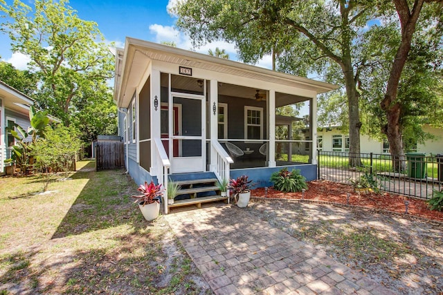 view of outdoor structure featuring a lawn and a sunroom