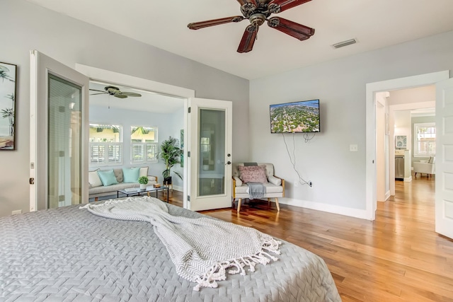 bedroom featuring french doors, hardwood / wood-style flooring, and ceiling fan