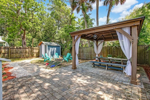 view of patio with a gazebo and a storage unit