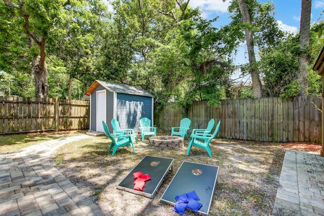 view of patio featuring a storage unit and an outdoor fire pit