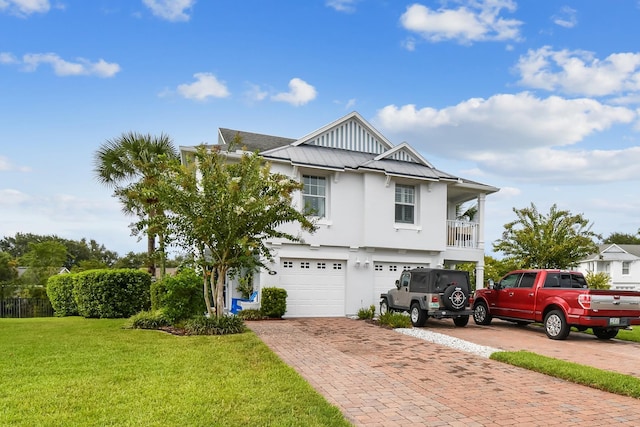 view of front of property featuring driveway, an attached garage, a front lawn, board and batten siding, and stucco siding