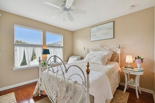 bedroom featuring a ceiling fan, baseboards, and wood finished floors