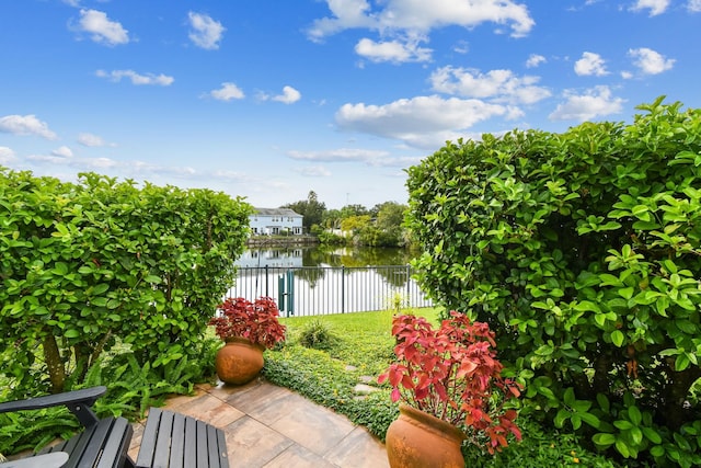 exterior space with a water view and fence