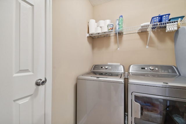 washroom with laundry area and washing machine and clothes dryer