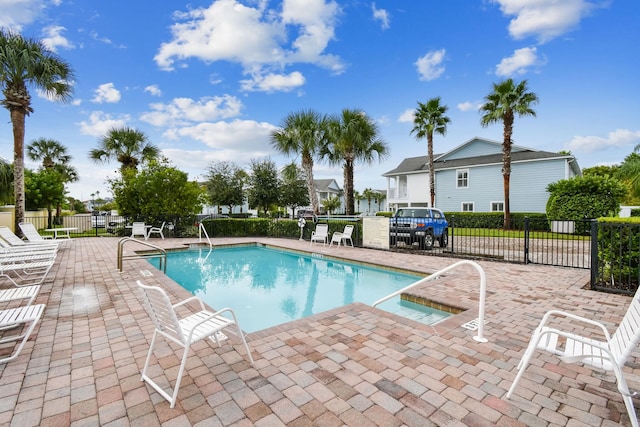 pool with fence and a patio