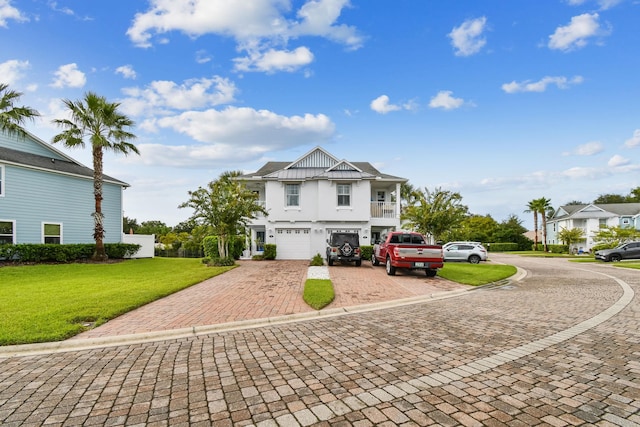 view of front of property featuring a front lawn, decorative driveway, and an attached garage