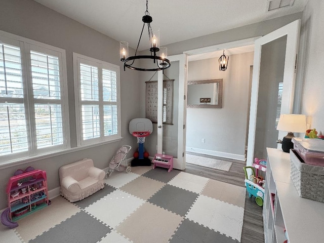 playroom featuring a chandelier