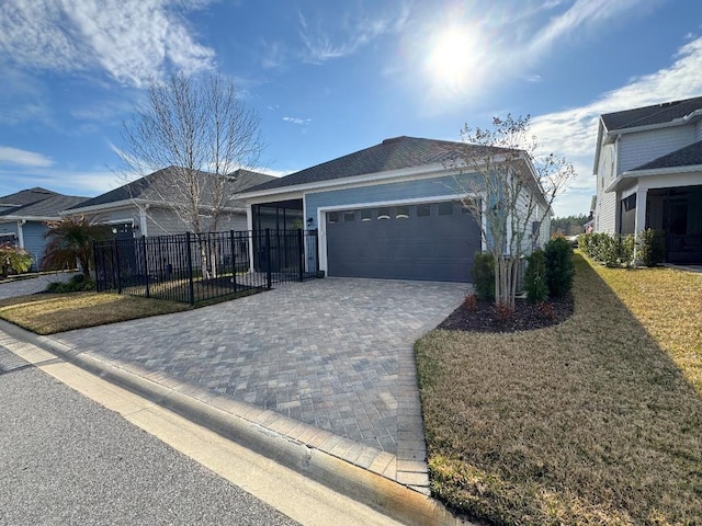 single story home with a garage and a front lawn