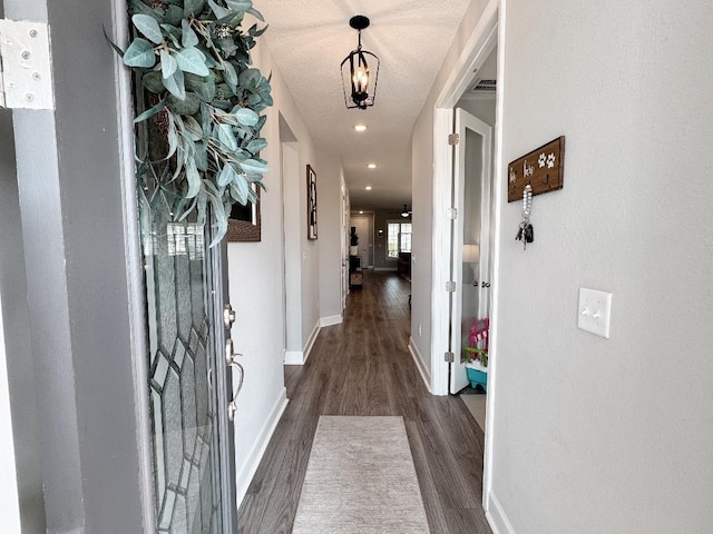 hallway with dark hardwood / wood-style floors