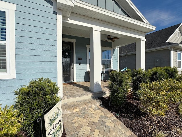 view of exterior entry featuring ceiling fan