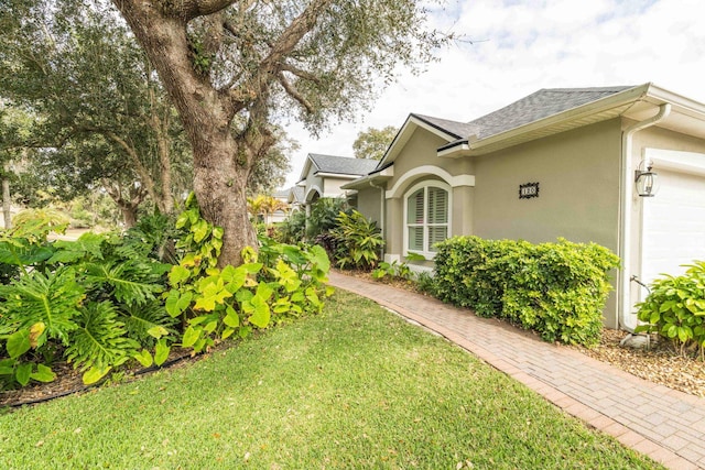 view of side of home with a lawn