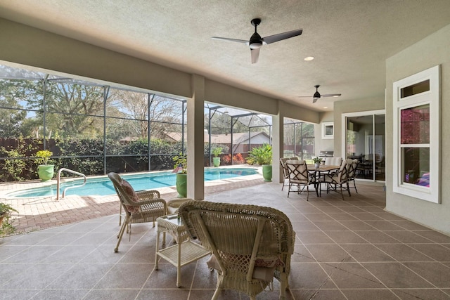 view of patio / terrace with a fenced in pool, a lanai, and ceiling fan