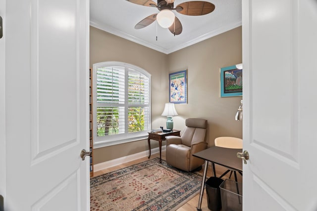 living area with ceiling fan, ornamental molding, and hardwood / wood-style floors