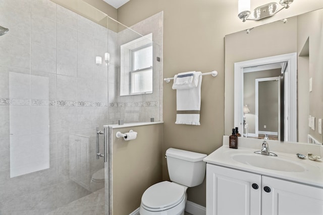 bathroom with vanity, toilet, and a shower with door