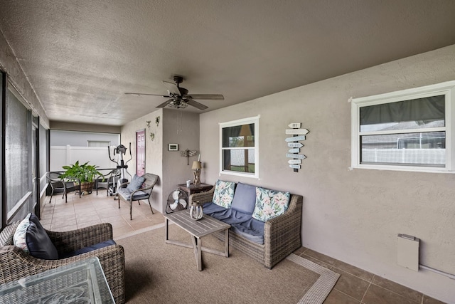 sunroom / solarium featuring ceiling fan