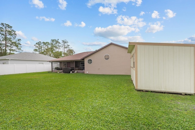 back of property featuring a sunroom and a yard