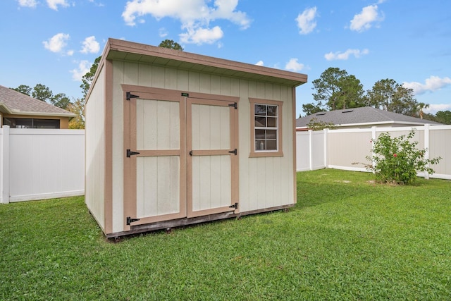 view of outbuilding with a yard