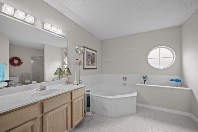 bathroom featuring tile patterned flooring, vanity, shower with separate bathtub, and a textured ceiling