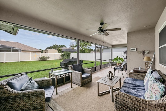 sunroom featuring ceiling fan